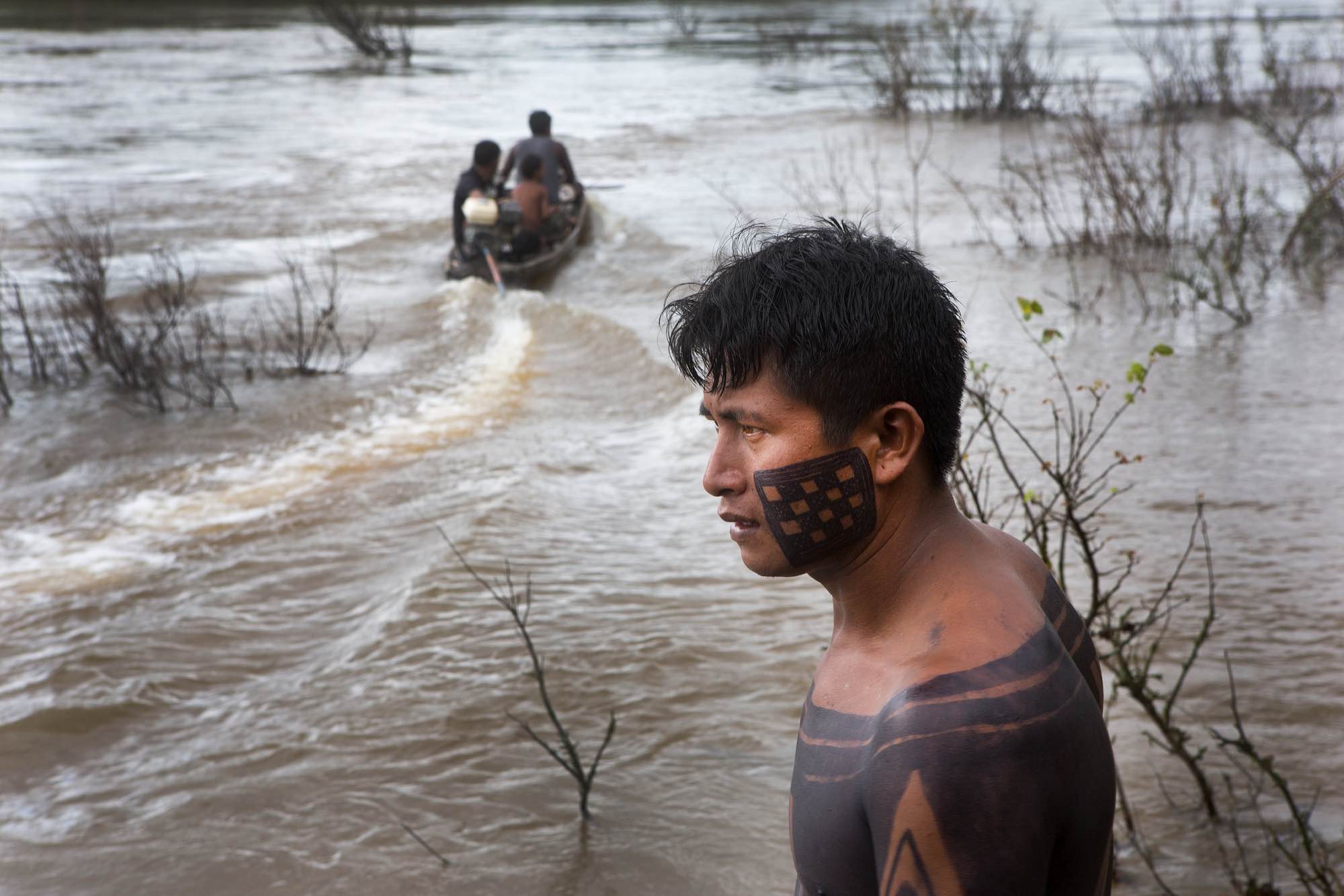 A fishing boat motors through a flooded area on the Bacaja River near Poti-Krô.