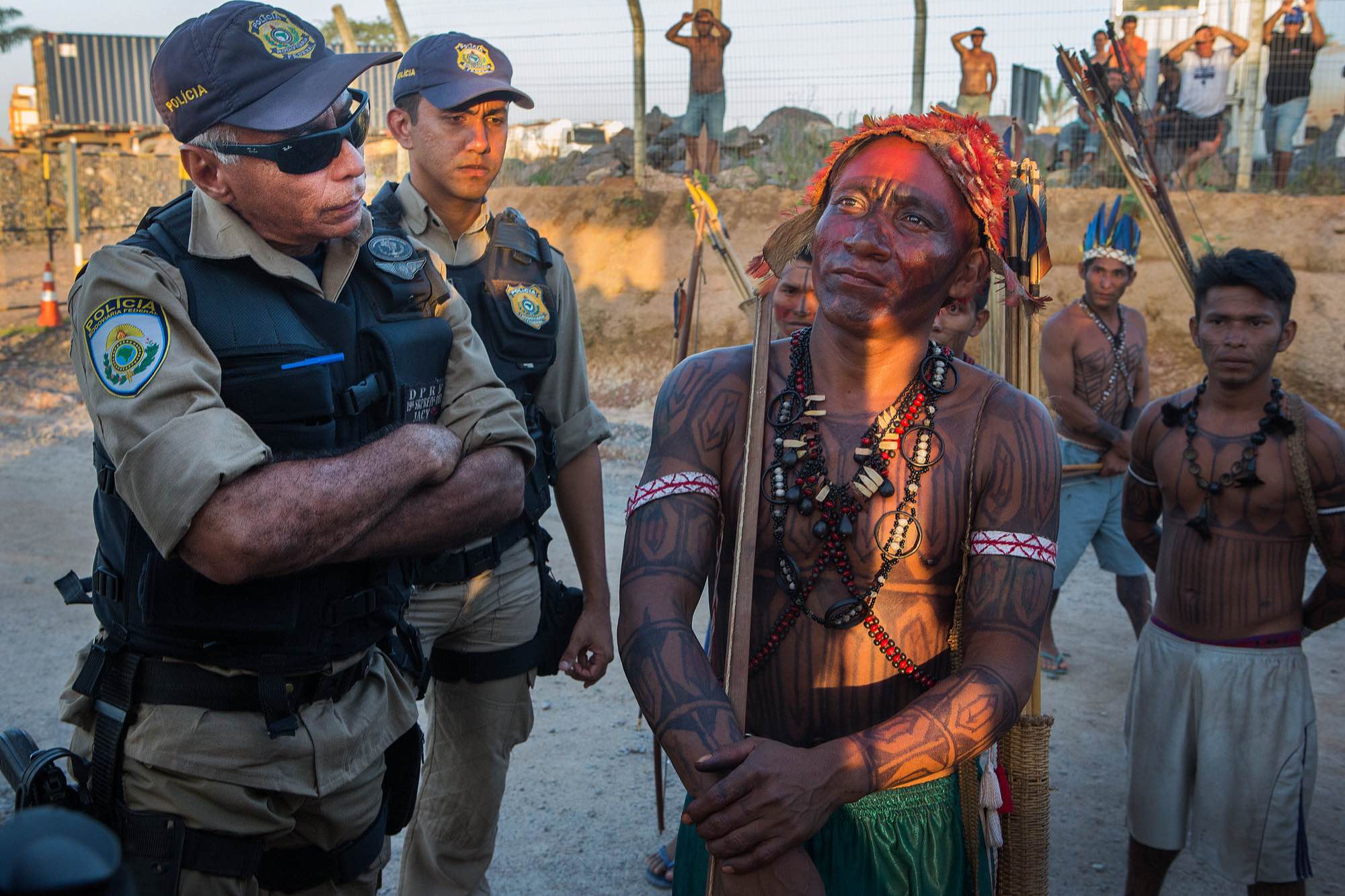 An indigenous Munduruku man and member of the Federal Police argue during an occupation of the Belo Monte Dam.