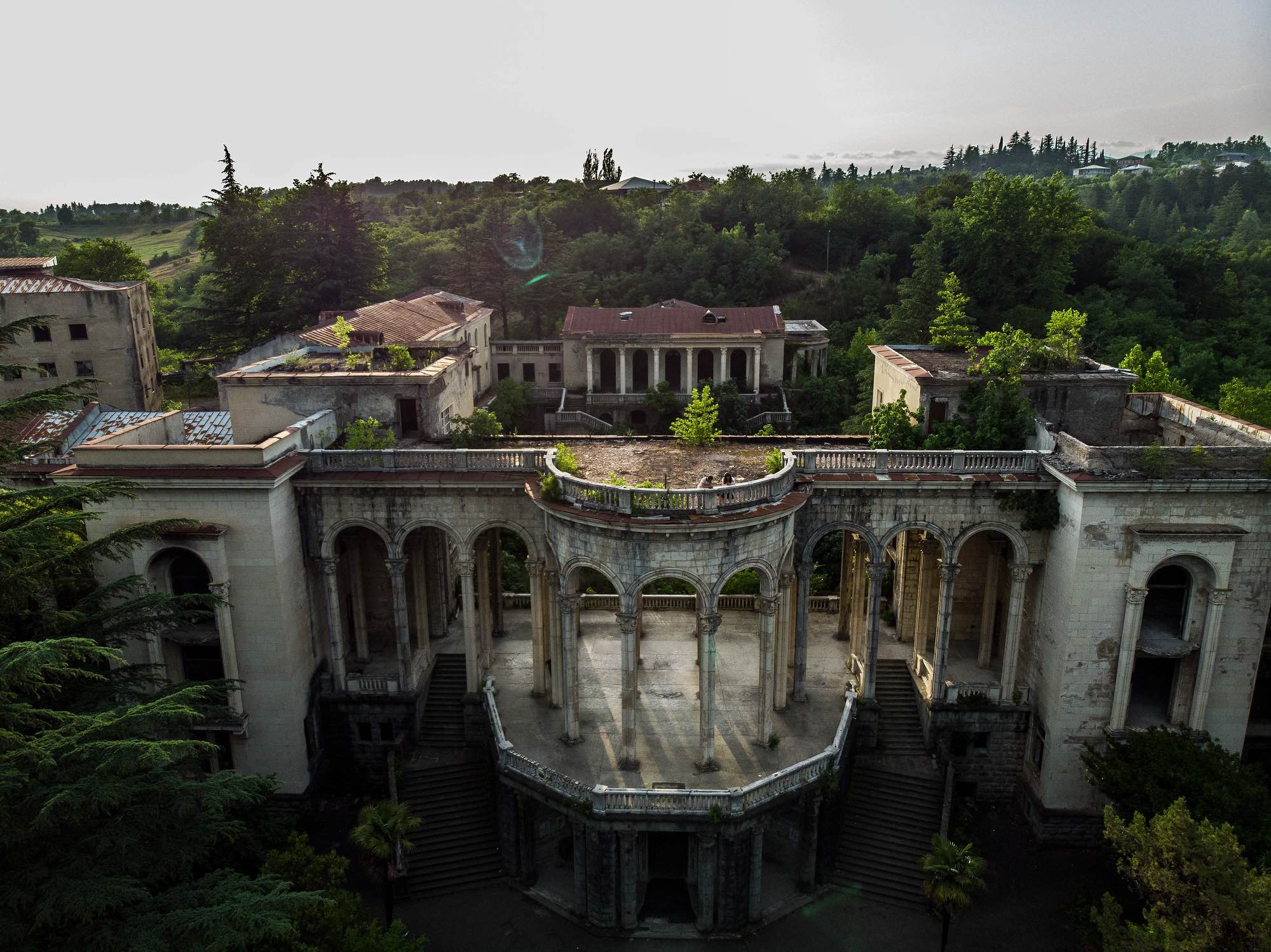 A couple on a date stand atop Sanatorium Medea in Tskatulbo, Georgia on June 15, 2019.
