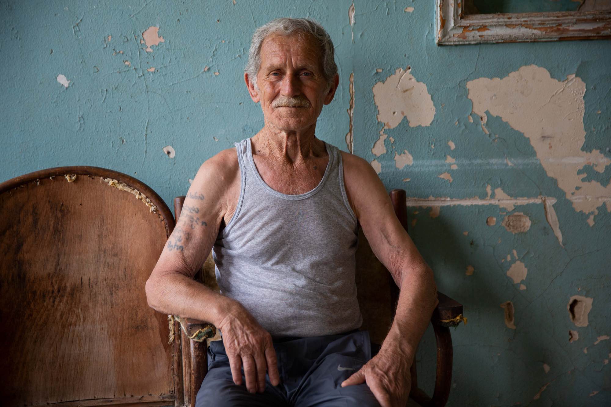 Nodari Kometiani, 80, sits outside his room at Sanatorium Imereti in Tskatulbo, Georgia on June 15, 2019.