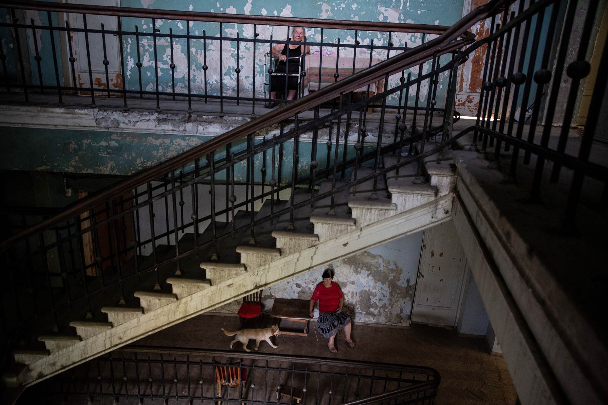 Lamze Giorgadze, 78, sits on an upstairs landing at Sanatorium Medea in Tskatulbo, Georgia on June 15, 2019.