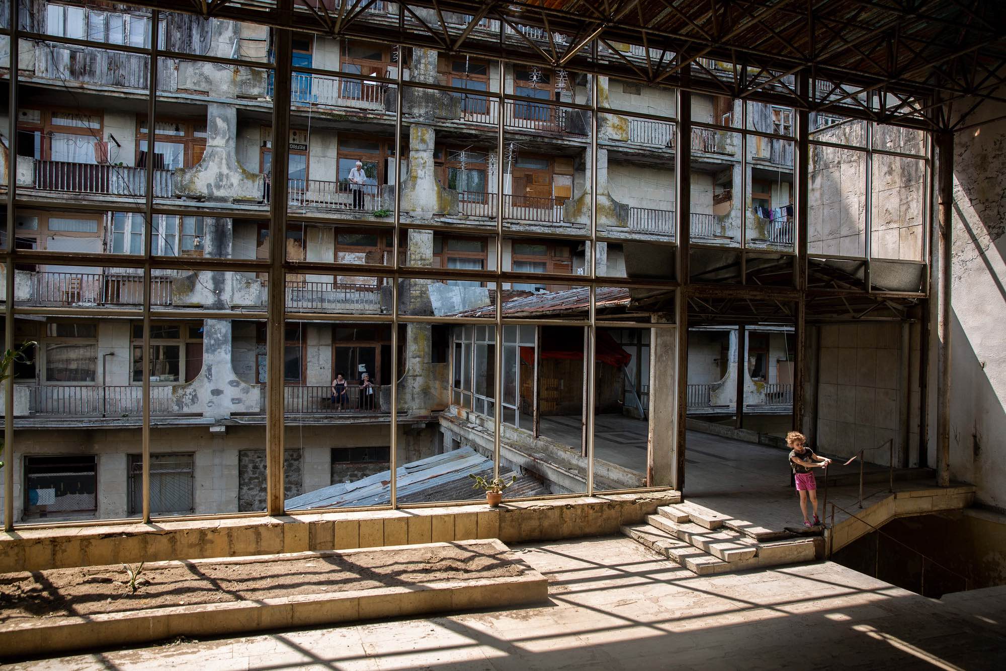 Barbare Metreveli (8) plays in a former restaurant across from the rooms at Sanatorium Samgurali in Tskatulbo, Georgia on June 15, 2019.