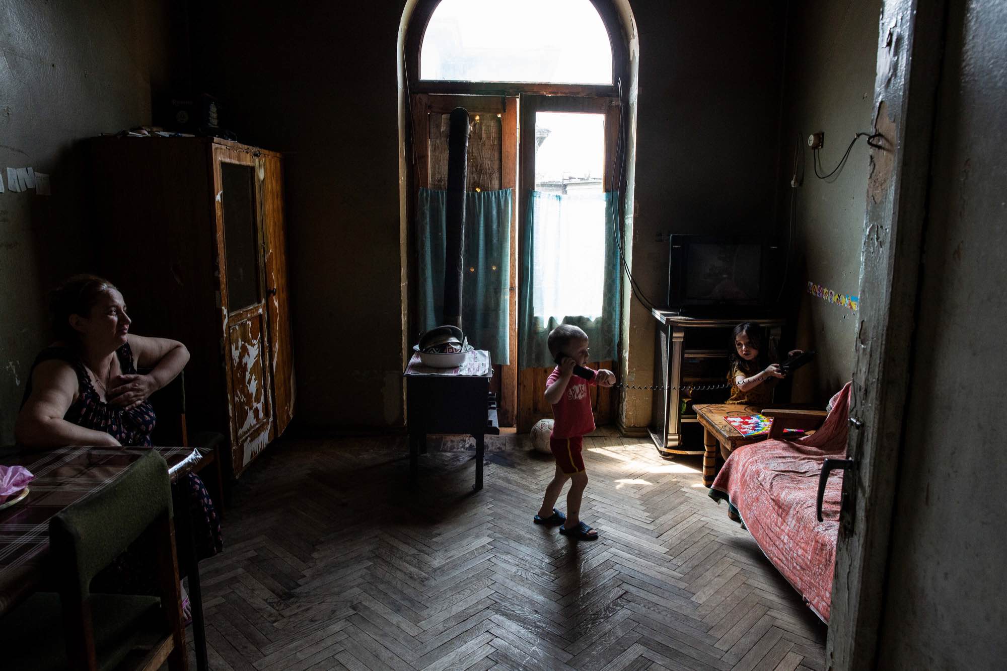 Nargize Chkhubadze watches as her children, Mariam and Oto, play at Sanatorium Imereti in Tskatulbo, Georgia on June 15, 2019.