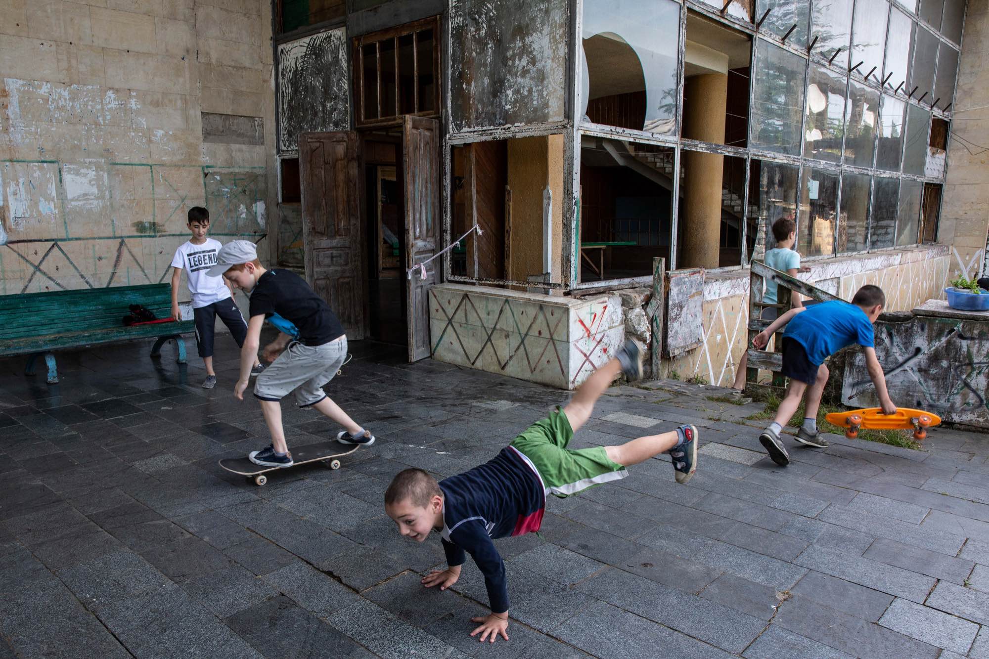 IDP children play outside an abandoned Sanatorium in Tskatulbo, Georgia on June 15, 2019.