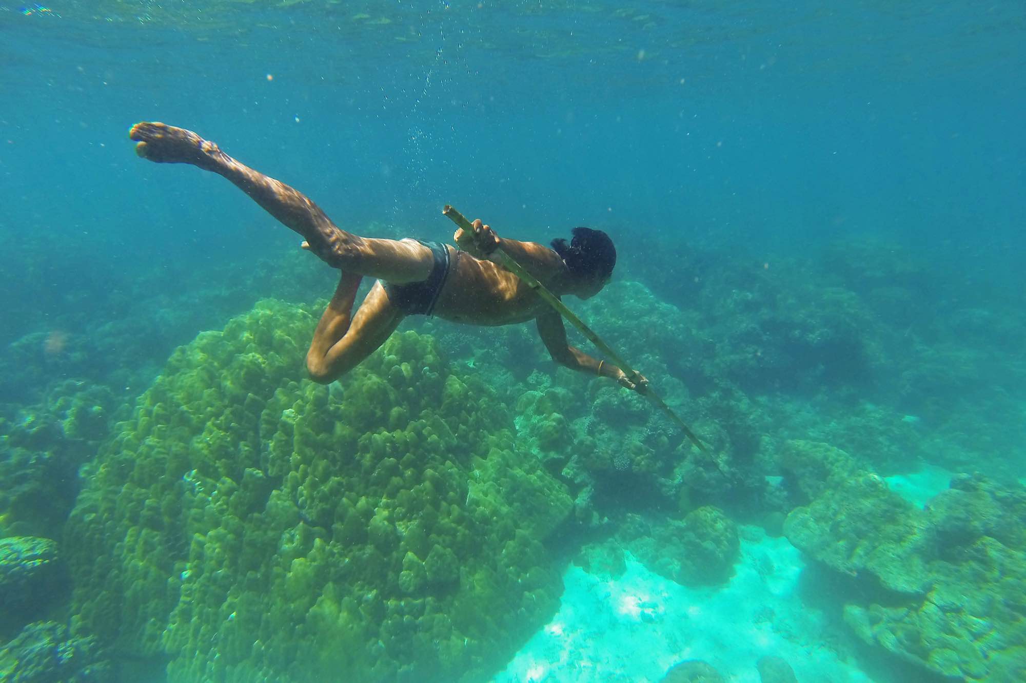 Danong, an indigenous Moken man, hunts for fish using a traditional bamboo spear near his village in Ko Surin National Park, Thailand.