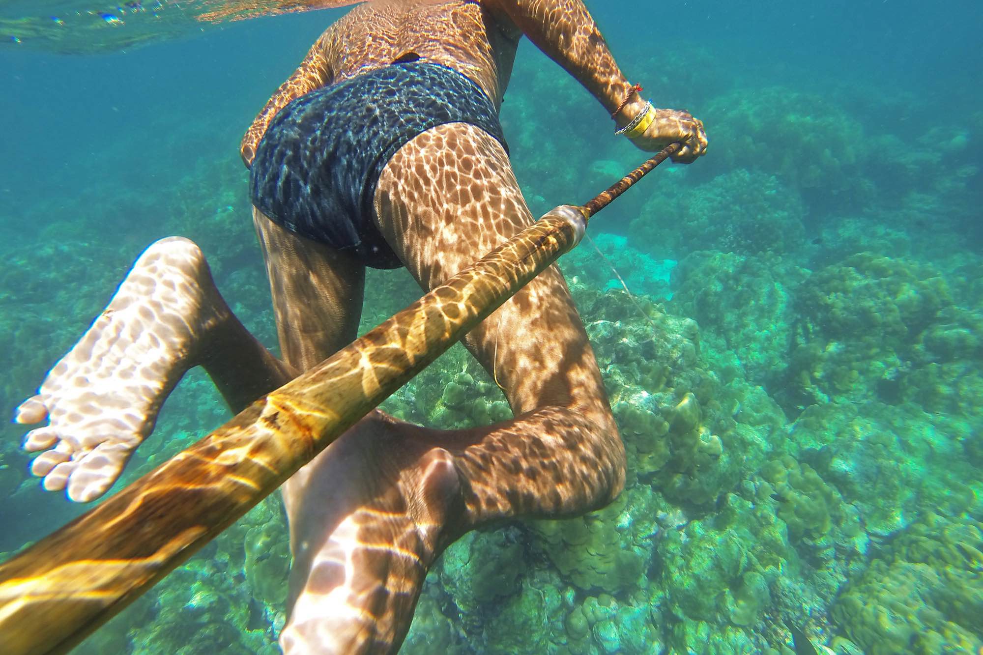Danong, an indigenous Moken man, hunts for fish using a traditional bamboo spear near his village in Ko Surin National Park, Thailand.