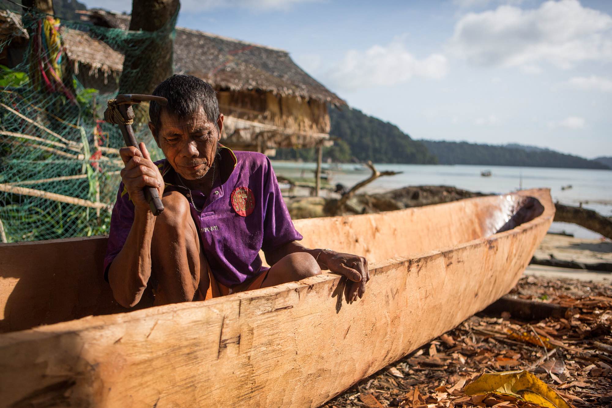 A Moken man builds a small boat (called Sampan) in his village in the Ko Surin National Park, Thailand.