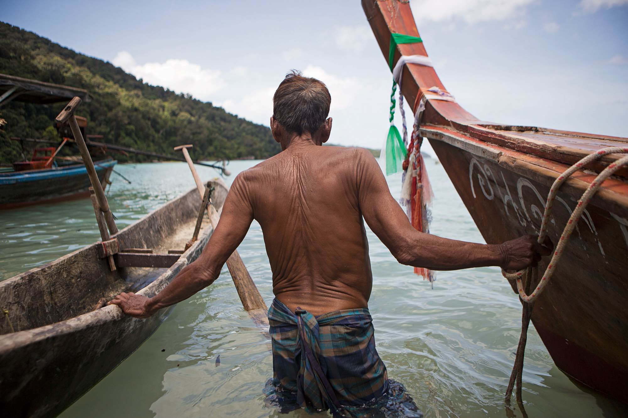 An indigenous Moken man takes his boat out from the beach near his village in Ko Surin National Park, Thailand.