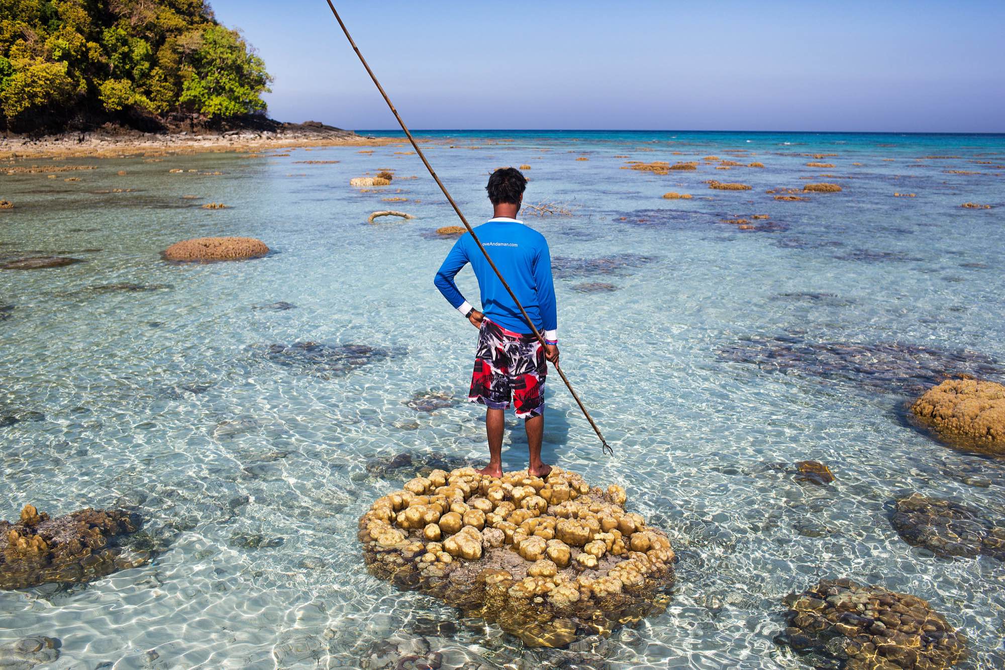 Hook, an indigenous Moken man, holds a three-pronged throwing spear and searches for fish in the waters of Ko Surin National Park.