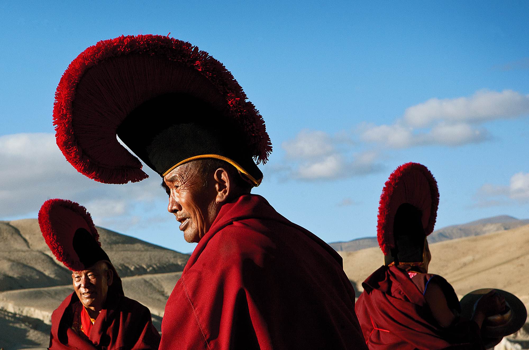 A group of senior monks gather for a ceremony on a field outside of Lo Manthang.