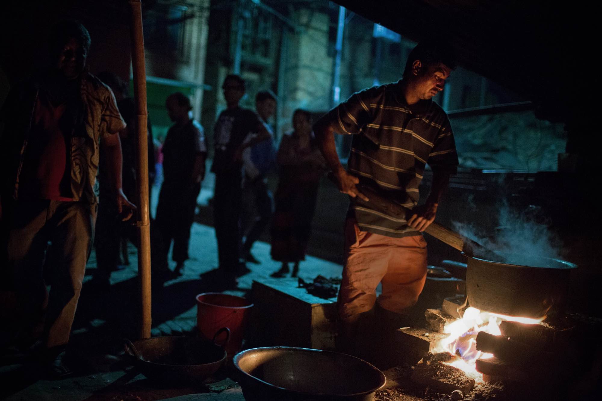 A Nepali man cooks food for dozens of displaced residents in Bhaktapur, Nepal on May 5, 2015.