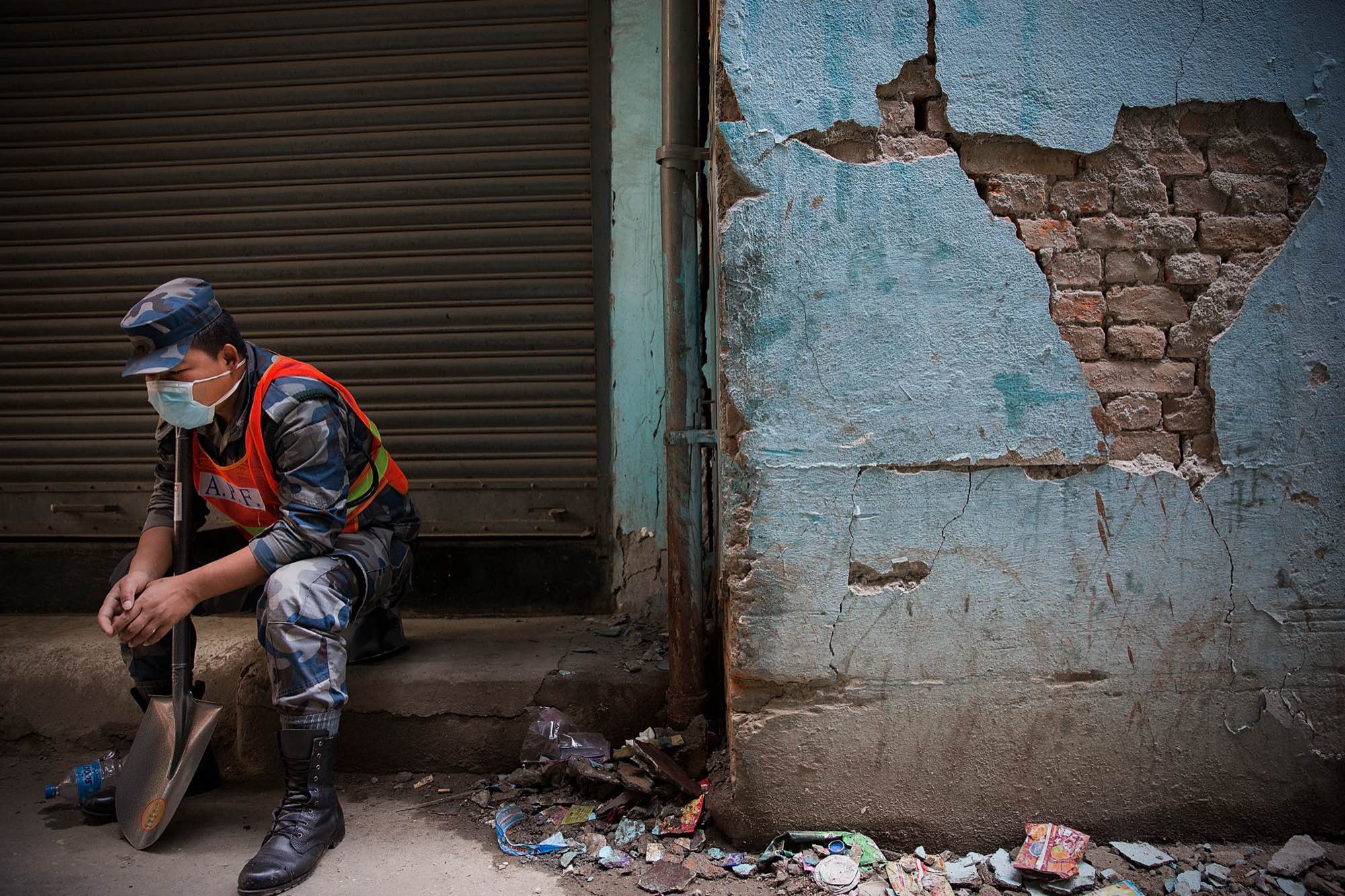 A tired Nepali soldier takes a break from rescue efforts in Kathmandu, Nepal on May 1, 2015.