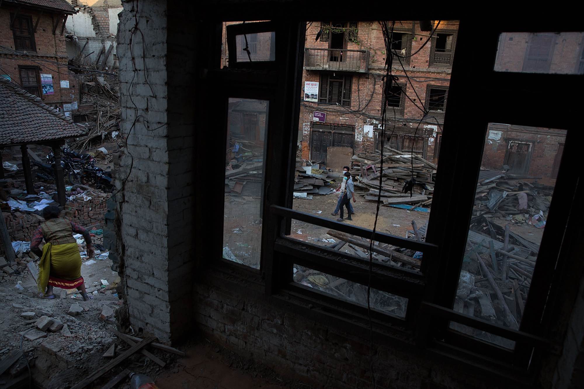 Nepali residents clear rubble and collect items from their destroyed homes in Bhaktapur, Nepal on May 5, 2015.