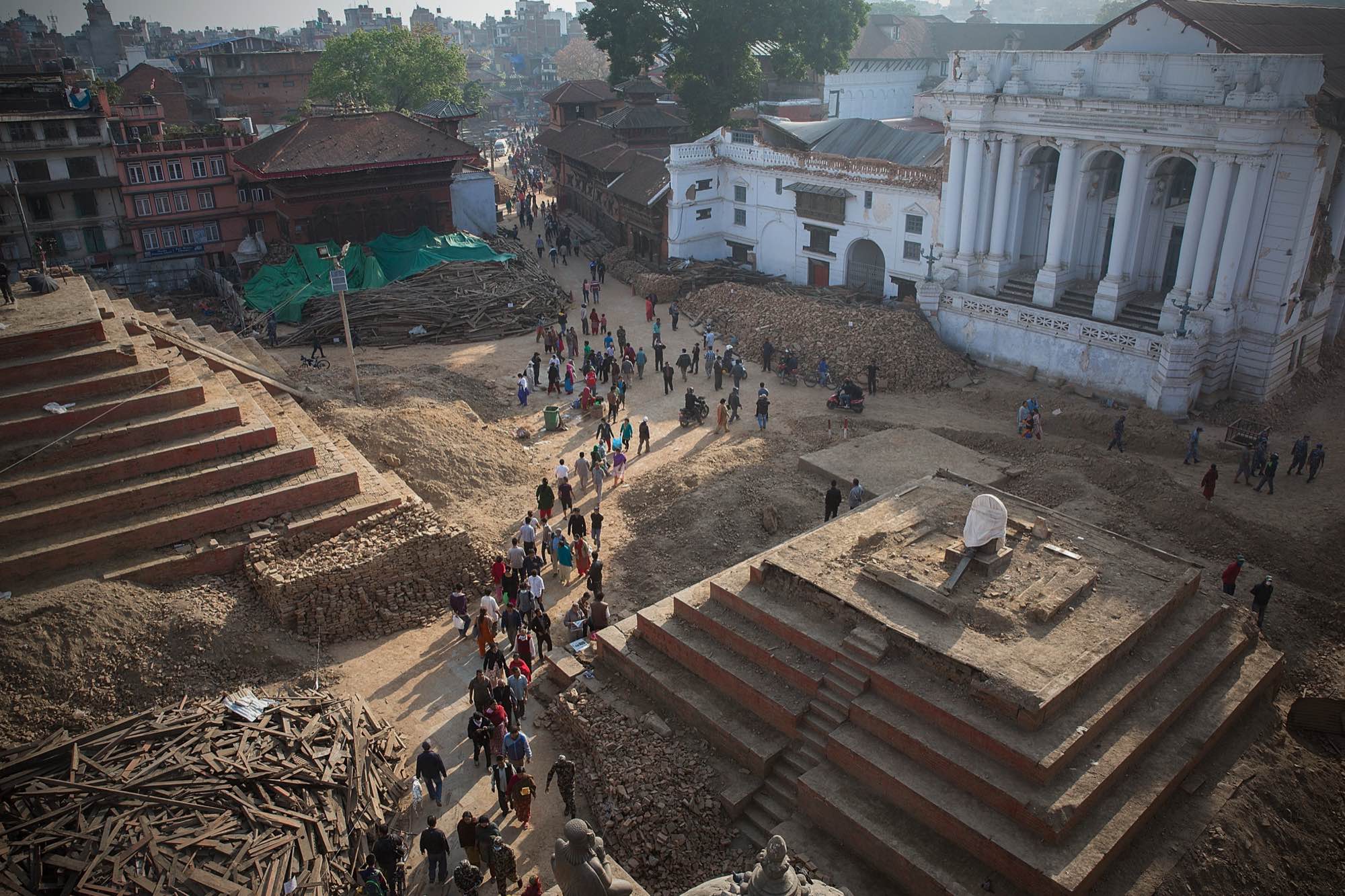 Locals and tourists walk through the ruins of Durbar Square in Kathmandu, Nepal on May 2, 2015.
