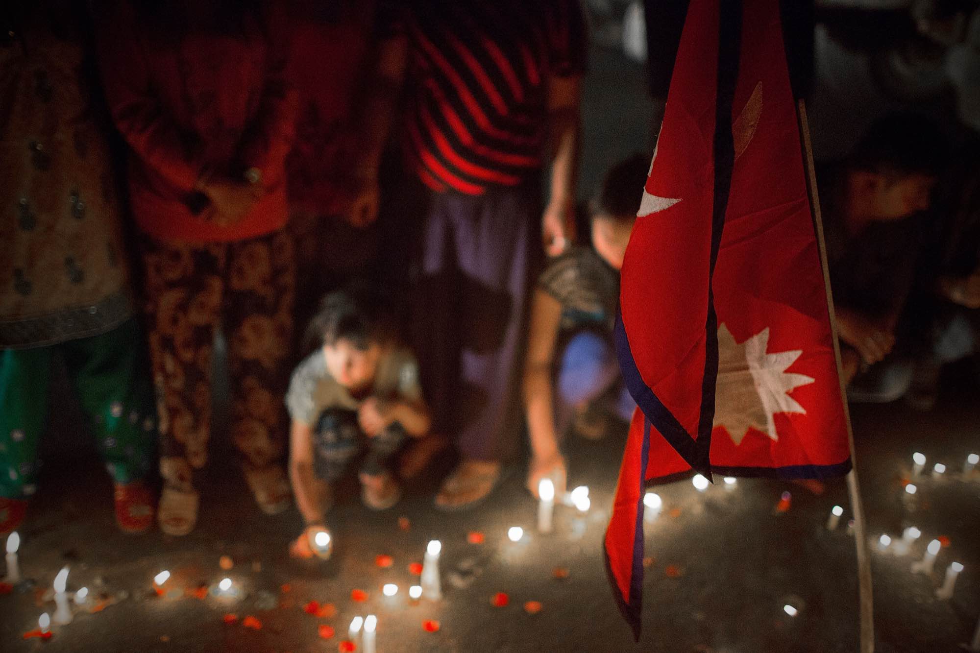 Nepali residents take part in a candle lighting ceremony for those lost in the earthquake on a street in Kathmandu, Nepal on May 4, 2015.