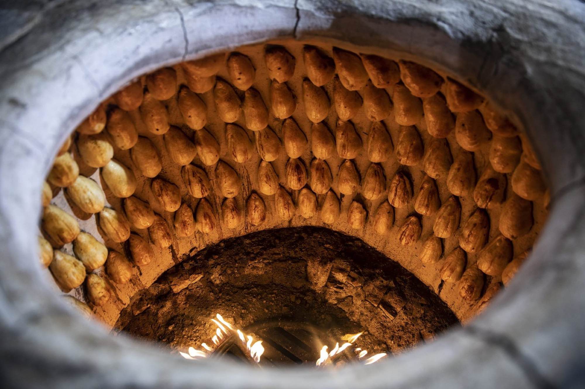Samsa baking in a tandoor in Uzbekistan